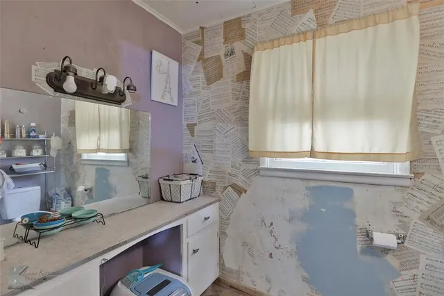 a room with a sink and a window