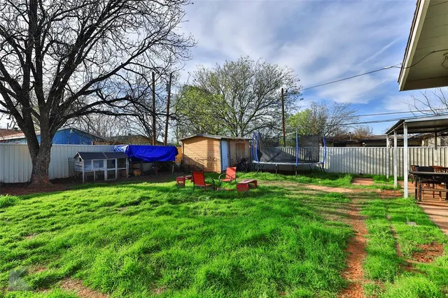 a view of backyard with deck and seating space
