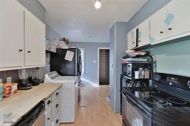 a kitchen with stainless steel appliances granite countertop a stove and a refrigerator