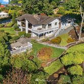 an aerial view of residential house with outdoor space and swimming pool