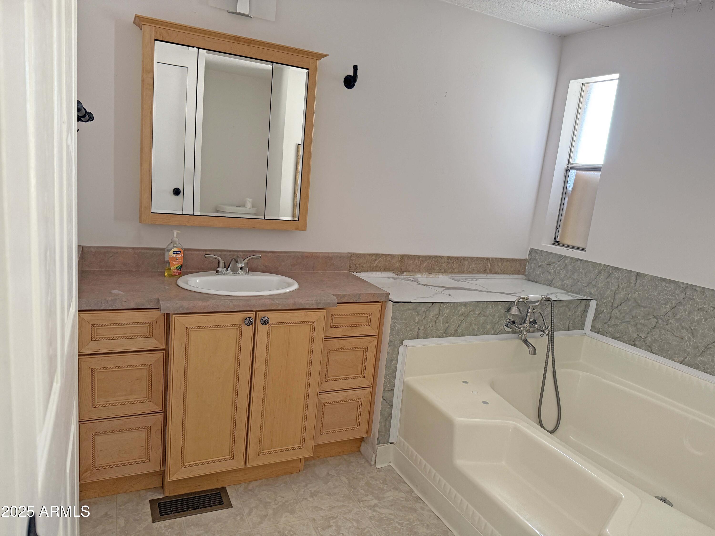 4715 North Drifting Sands Road Rimrock, AZ 86335 - Photo 16 of 39 a bathroom with a granite countertop sink and mirror with bathtub
