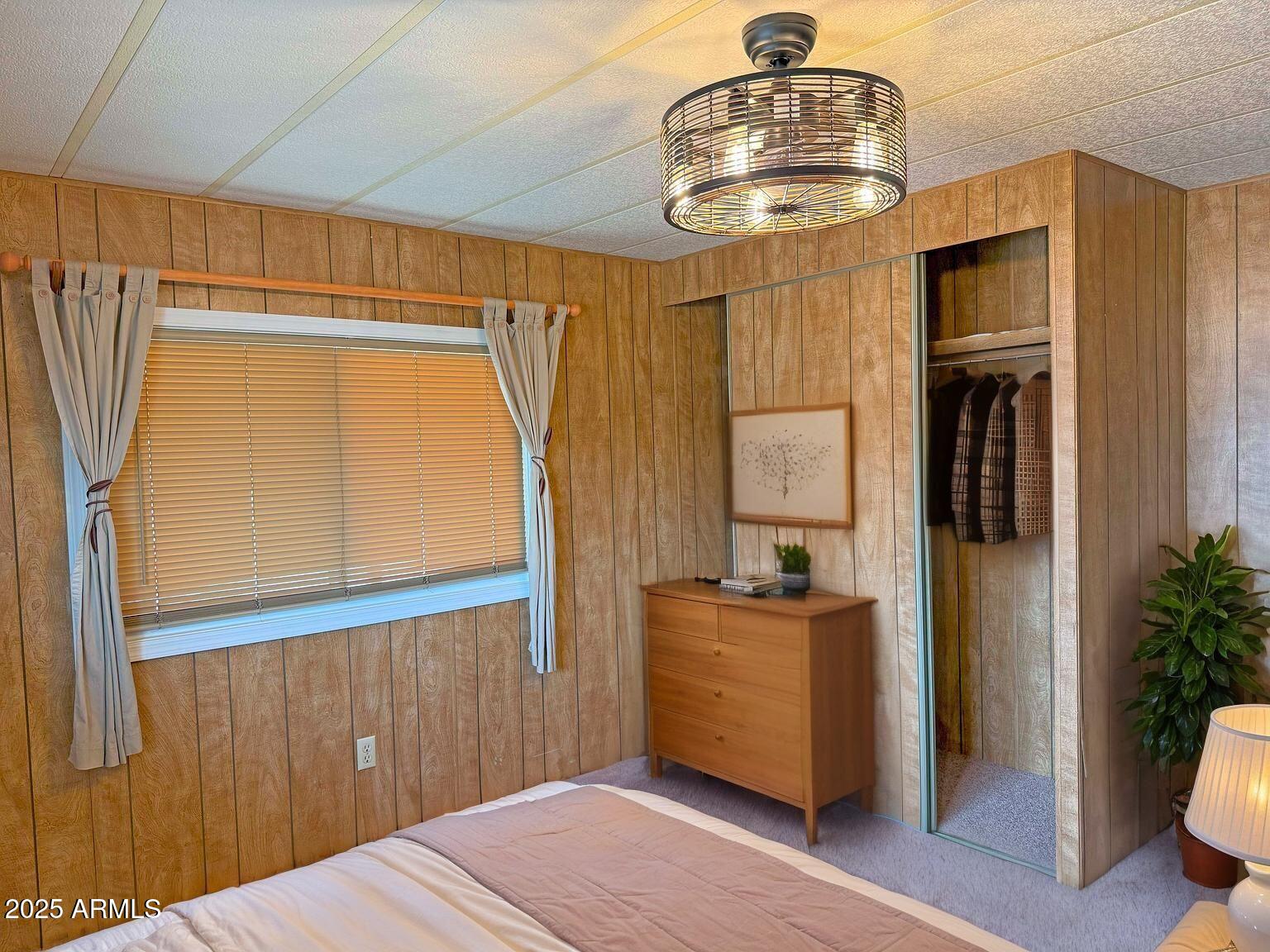 4715 North Drifting Sands Road Rimrock, AZ 86335 - Photo 24 of 39 a bedroom with a bed and a chandelier