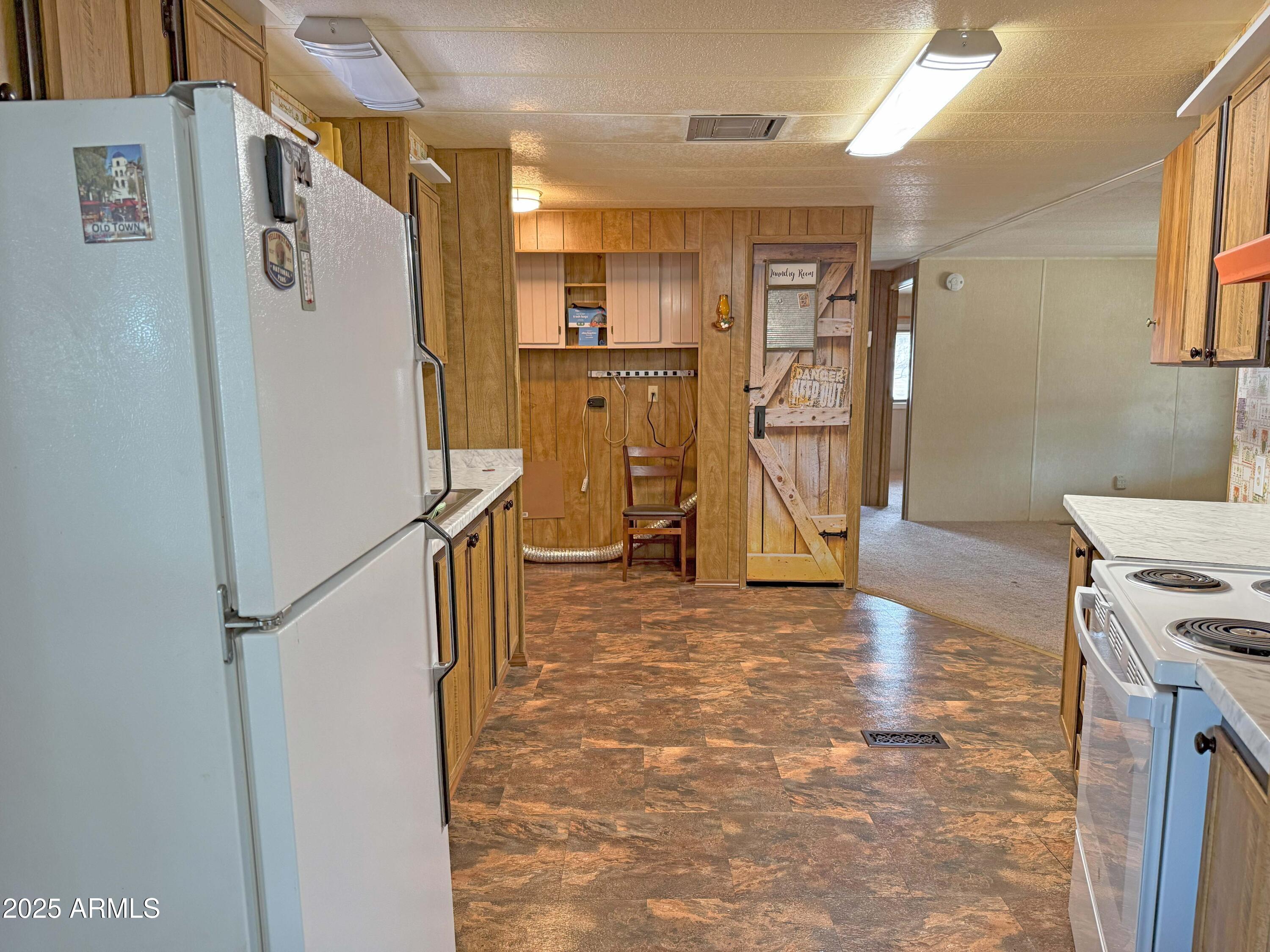 4715 North Drifting Sands Road Rimrock, AZ 86335 - Photo 8 of 39 a view of a kitchen with refrigerator and wooden floor