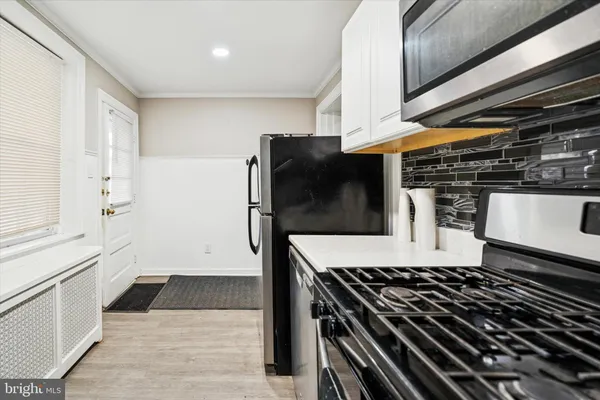 a kitchen with stainless steel appliances granite countertop a stove and a refrigerator