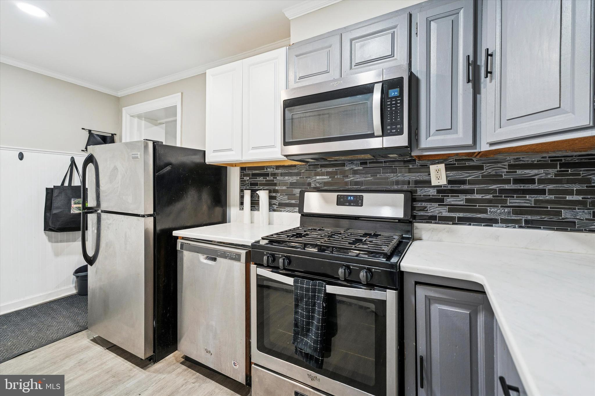 352 Carson Street Philadelphia, PA 19128 - Photo 14 of 35 a kitchen with stainless steel appliances granite countertop a stove microwave and refrigerator