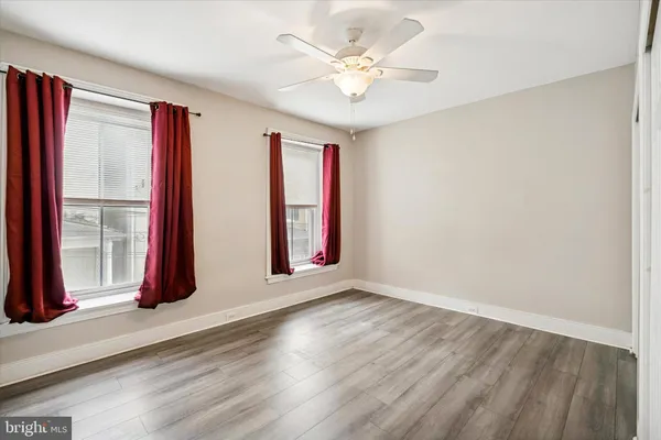 an empty room with windows and closet