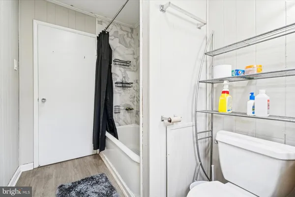 a bathroom with a shower toilet and sink