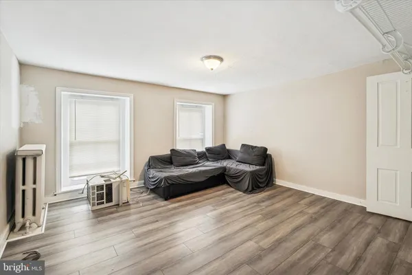 a living room with furniture windows and wooden floor