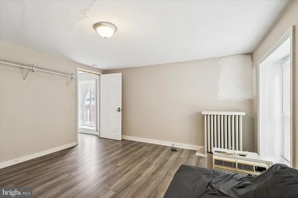a view of a room with wooden floor