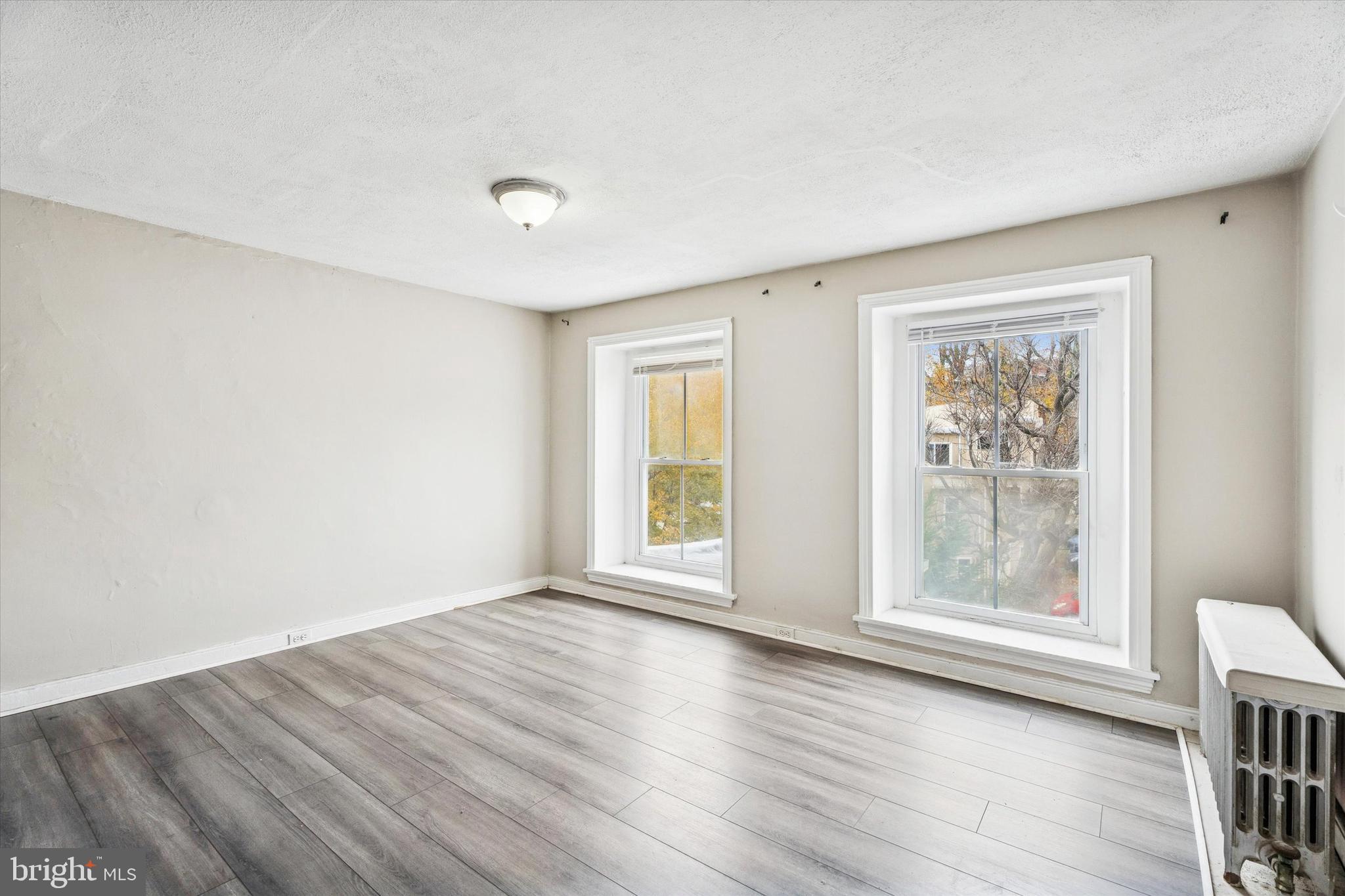 352 Carson Street Philadelphia, PA 19128 - Photo 27 of 35 a view of an empty room with wooden floor and a window