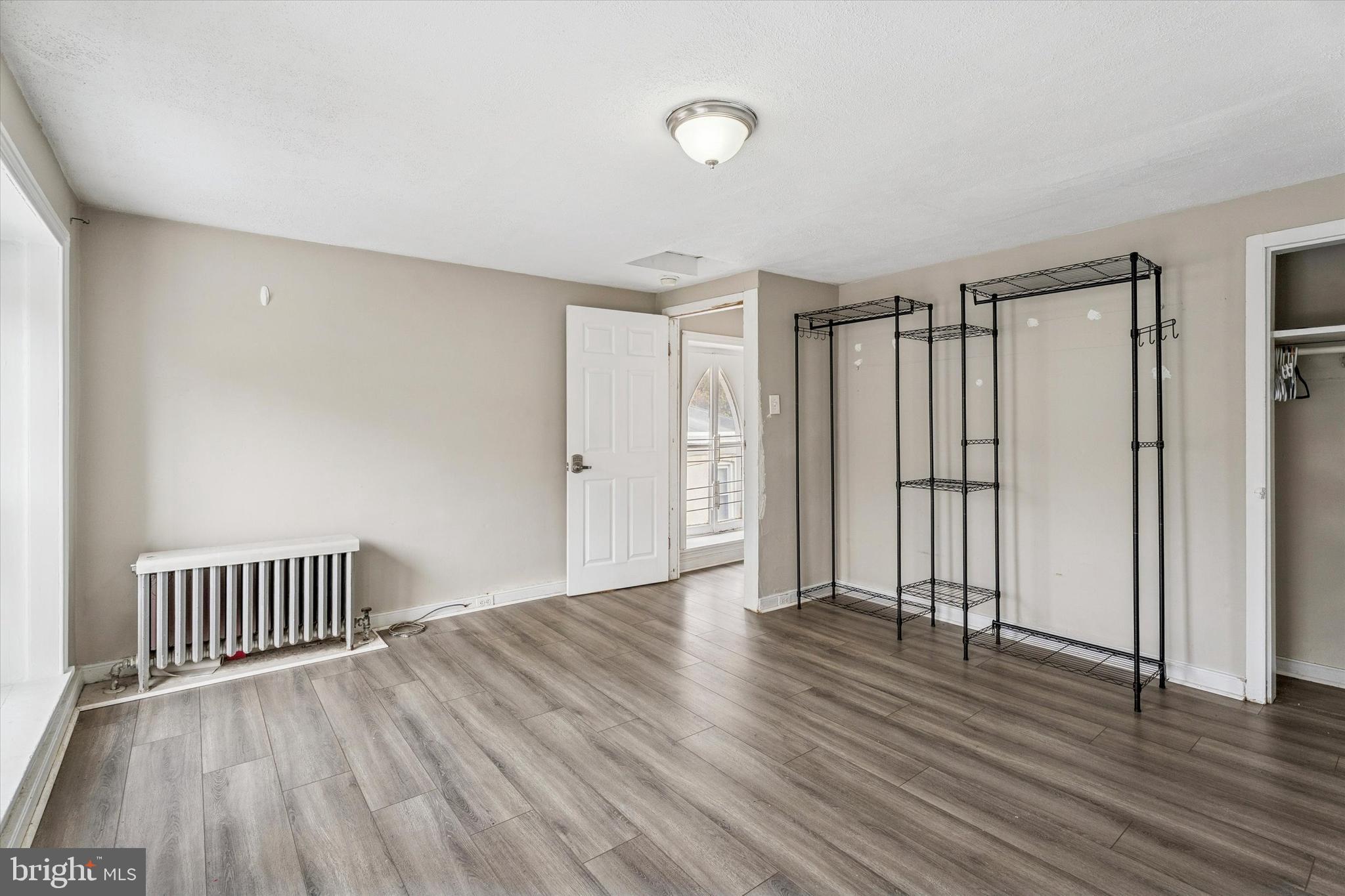 352 Carson Street Philadelphia, PA 19128 - Photo 29 of 35 an empty room with wooden floor and a yard