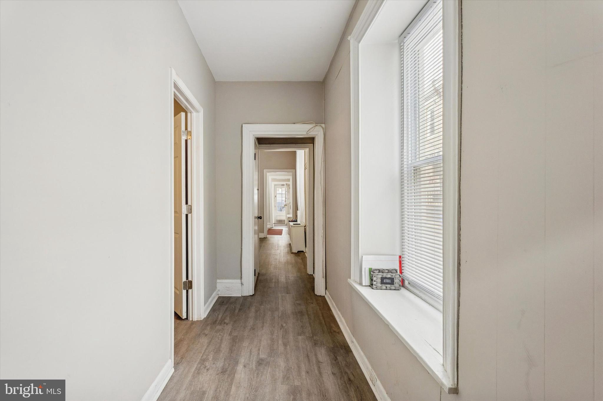 352 Carson Street Philadelphia, PA 19128 - Photo 30 of 35 a view of a hallway with wooden floor and a bathroom