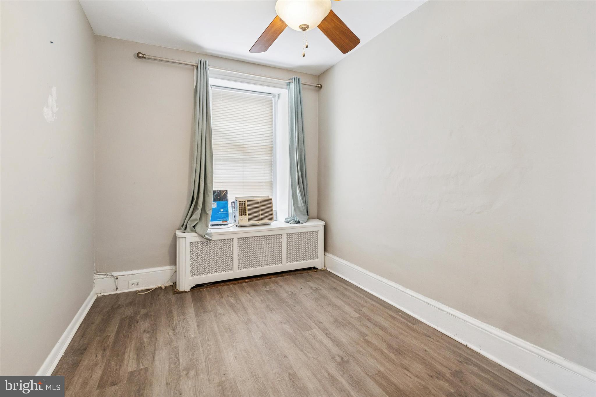352 Carson Street Philadelphia, PA 19128 - Photo 4 of 35 a view of an empty room with wooden floor and a window