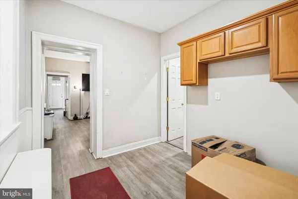 a view of a livingroom with wooden floor and cabinet