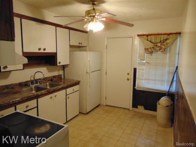 20495 Meyers Road Detroit, MI 48235 - Photo 5 of 7 Kitchen featuring range with electric stovetop, freestanding refrigerator, white cabinetry, dark countertops, and ceiling fan