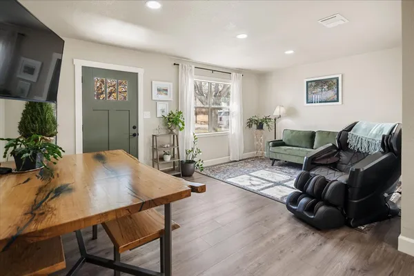a living room with furniture and wooden floor