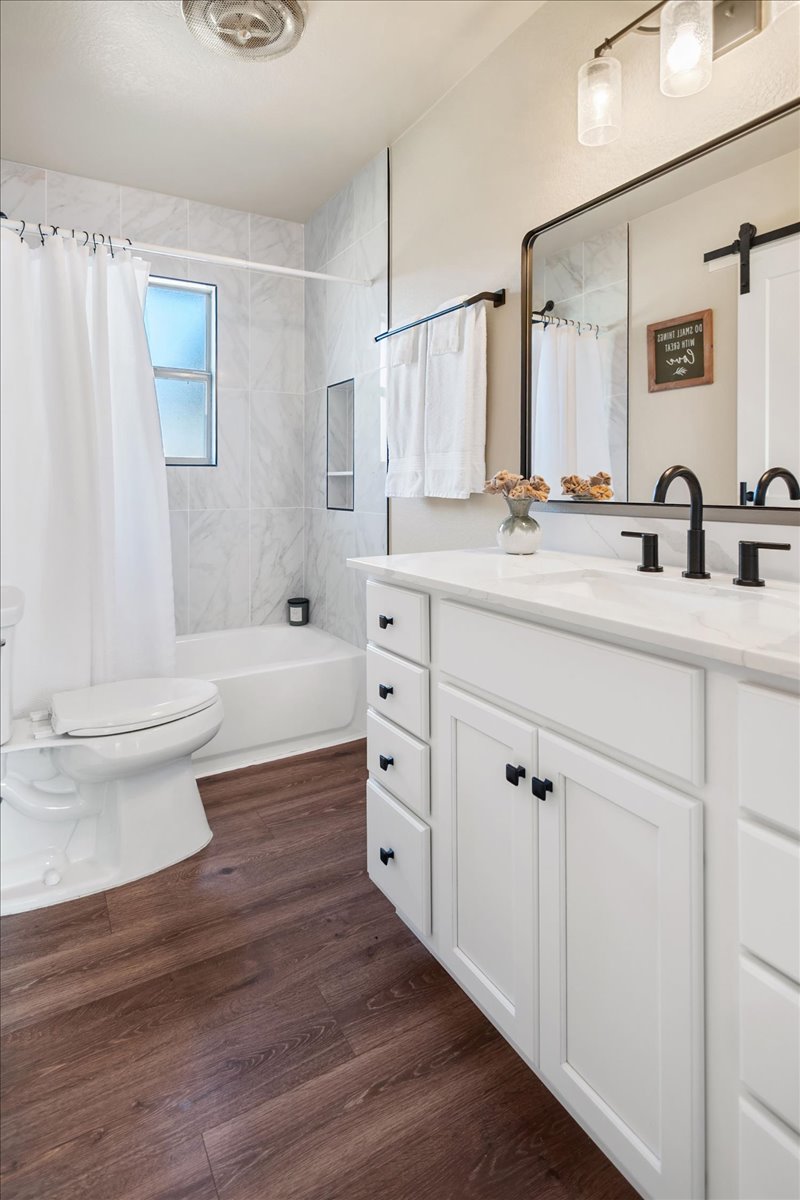1236 Martin Street Mason, TX 76856 - Photo 21 of 40 a bathroom with double vanity sink a mirror and a toilet