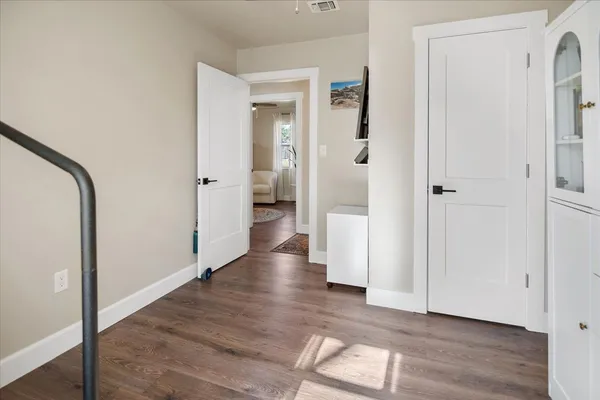 a view of a hallway with wooden floor
