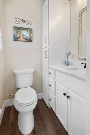 a bathroom with a toilet sink and mirror