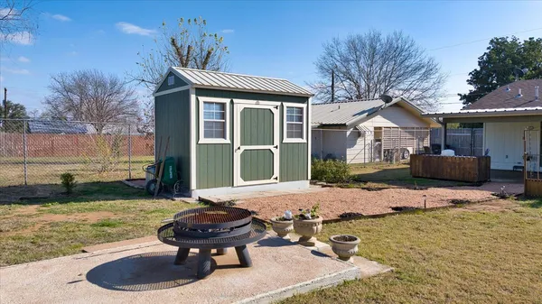 a backyard of a house with yard fire pit and outdoor seating