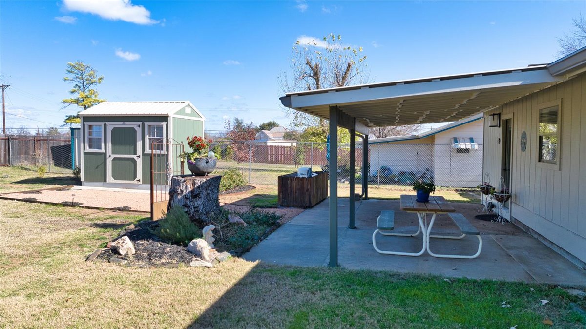 1236 Martin Street Mason, TX 76856 - Photo 35 of 40 a view of a patio with table and chairs potted plants and floor to ceiling window