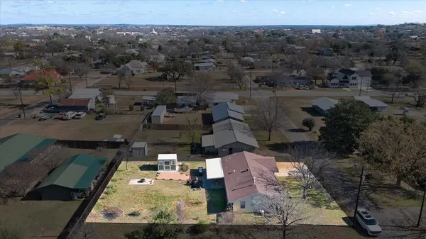 an aerial view of a house with a yard
