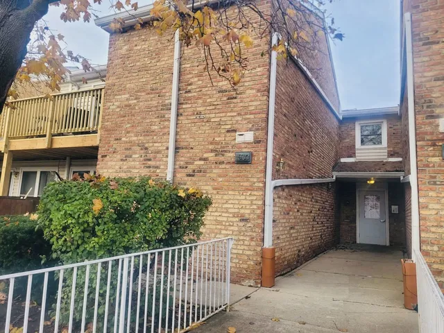 a view of a brick house with an outdoor space