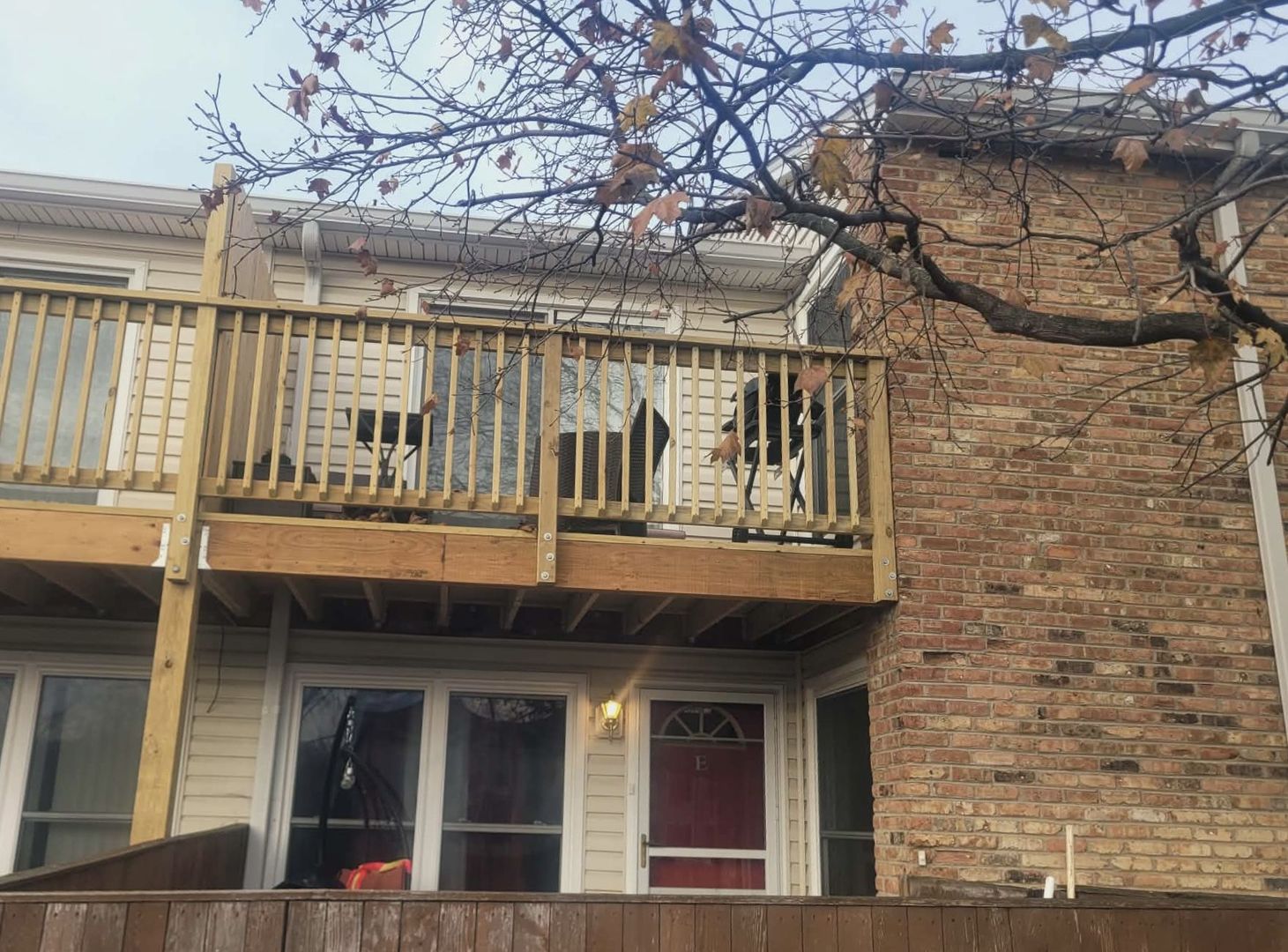 1930 Kenilworth Circle, Unit E Hoffman Estates, IL 60169 - Photo 13 of 13 a front view of a building with a tree