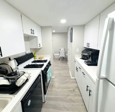 a kitchen with a sink a stove and refrigerator