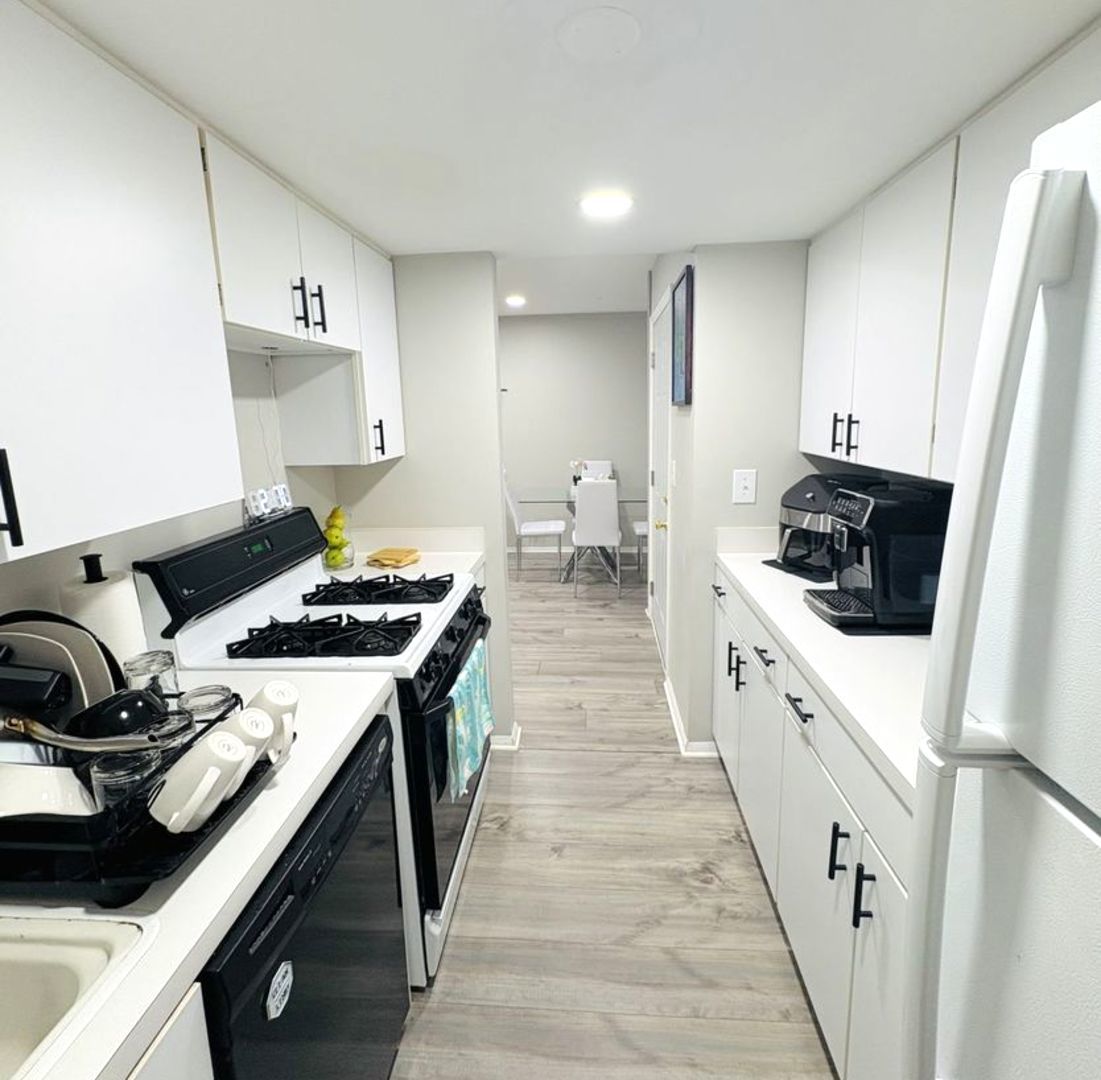 1930 Kenilworth Circle, Unit E Hoffman Estates, IL 60169 - Photo 4 of 13 a kitchen with a sink a stove and refrigerator