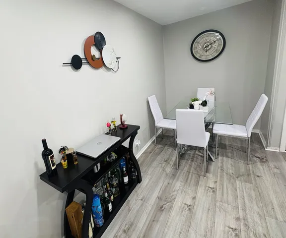 a view of a dining room and kitchen with furniture wooden floor