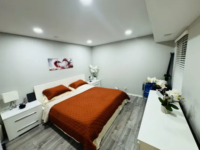 a bedroom with a bed and a couch