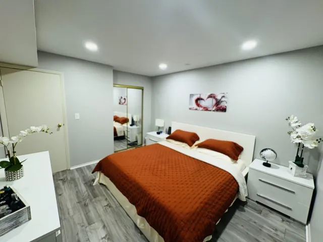 a bedroom with a bed and a couch