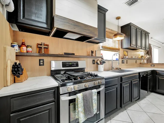 a kitchen with stainless steel appliances granite countertop a stove and a microwave