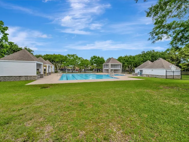 a view of house with garden and a yard