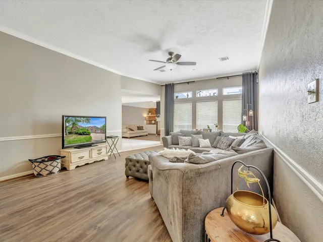 a living room with furniture appliances and a flat screen tv