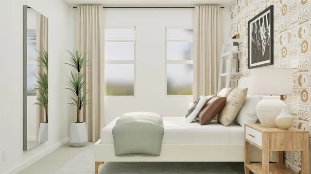 a bedroom with a bed and a painting on the wall