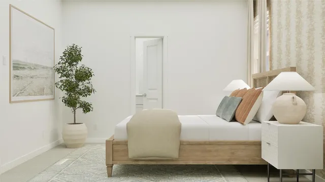 a bedroom with a bed and a potted plant