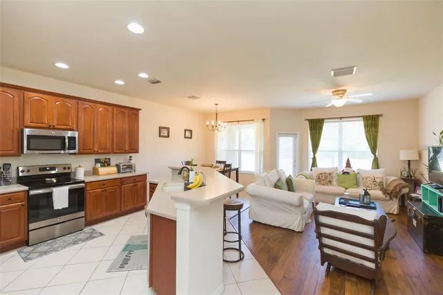a large kitchen with a large counter top appliances and cabinets
