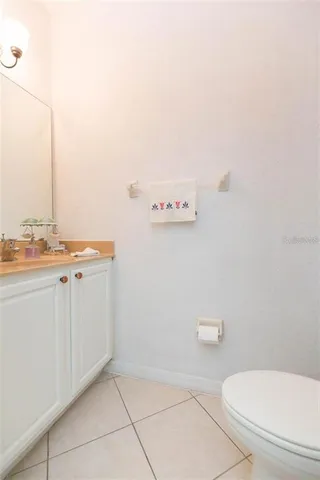 a bathroom with a toilet a sink and vanity