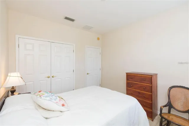 a bedroom with a bed and a chair