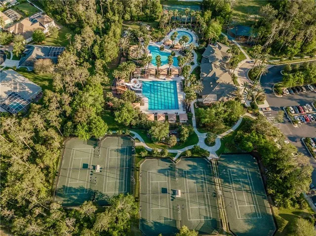an aerial view of a residential apartment building with a yard and plants