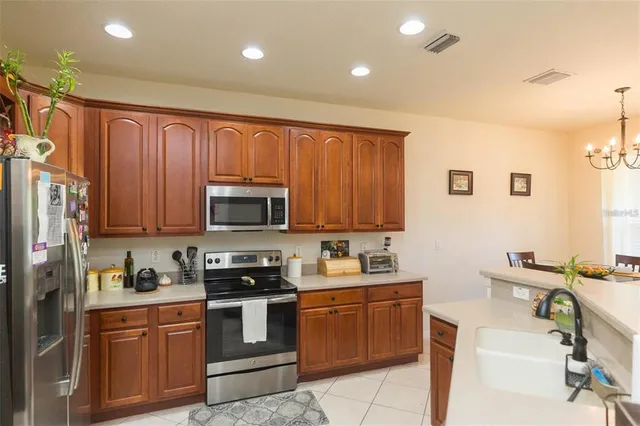 a kitchen with a sink cabinets and stainless steel appliances