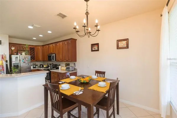 a view of a dining room with furniture and a chandelier