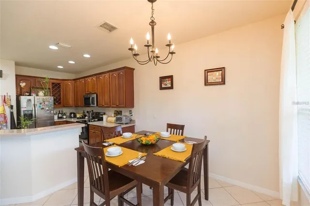 a view of a dining room with furniture and a chandelier