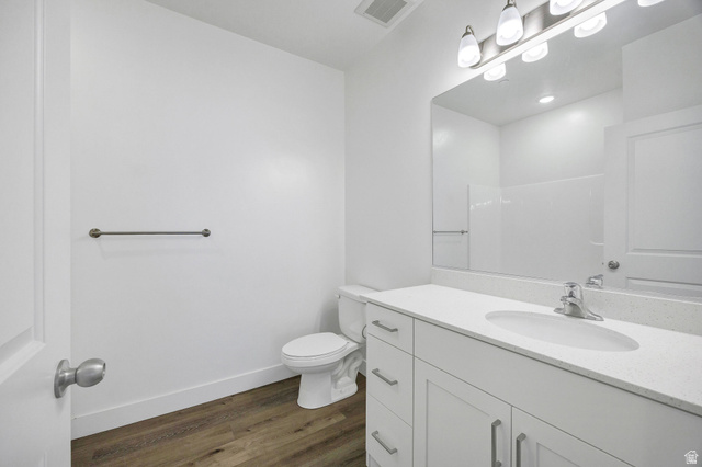 3115 South 200 West, Unit C201 Nibley, UT 84321 - Photo 13 of 23 Contemporary bathroom featuring a white vanity with integrated sink, a large mirror, and a modern light fixture