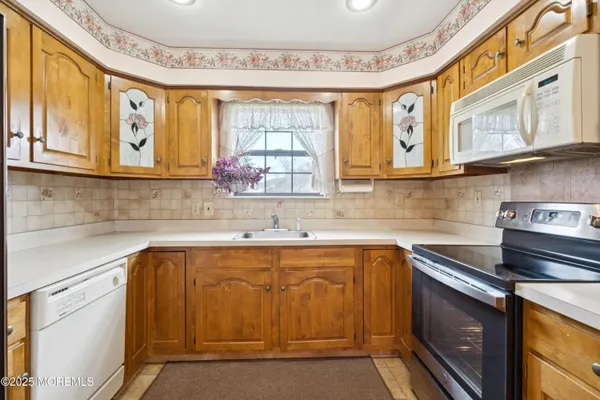 a kitchen with stainless steel appliances granite countertop a sink and cabinets