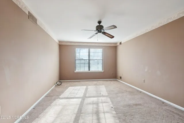 a view of room with a ceiling fan