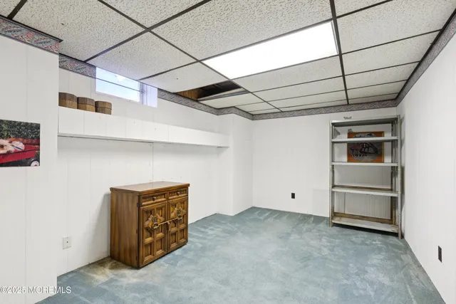 a view of a livingroom with furniture and a window