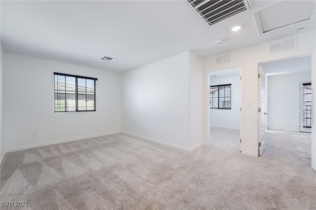 715 Pickled Pepper Place Henderson, NV 89011 - Photo 15 of 31 Empty room featuring light carpet and recessed lighting